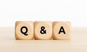Q and A or questions and answers concept. Wooden blocks with text on desk. Copy space